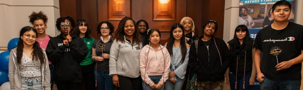 TRIO Talent Search seniors smiling and posing with Dr. Gaines at our graduation celebration